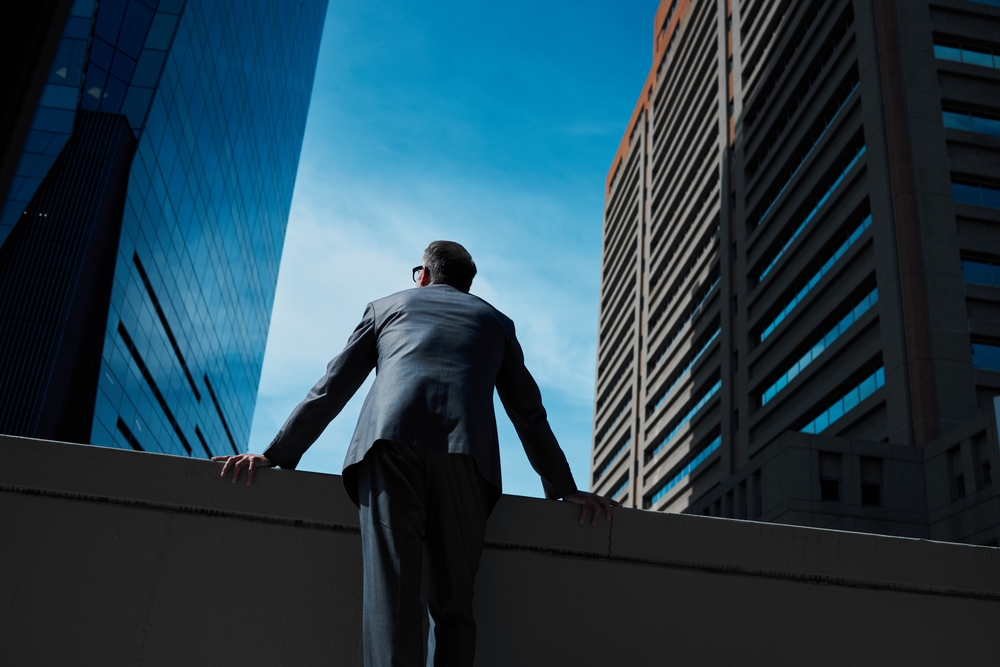 Man standing before skyscrapers