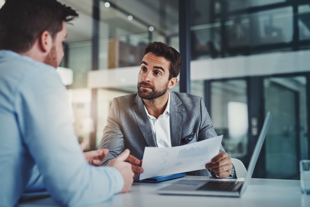 two men reviewing a contract